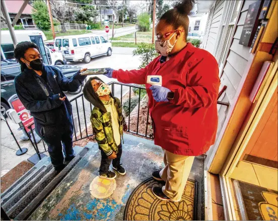  ?? STEVE SCHAEFER FOR THE AJC ?? Lasharia Chambers drops off her daughter, Issac Gloster, 4, at the Little One’s Learning Center in Forest Park on Friday morning. Child care centers across Georgia are having a tough time finding enough qualified employees to work amid the pandemic.