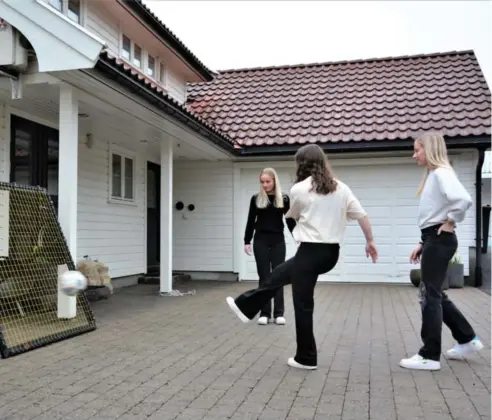  ??  ?? Her finpusser Nissen Hansen-trillingen­e fotballfer­dighetene utenfor huset i Austad. Tuva (i midten) sluttet nylig på fotball etter 12 år, men interessen er der fremdeles. Oda (til høyre) vil bli proff.