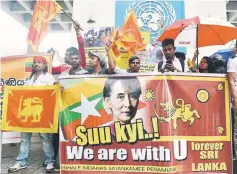  ??  ?? A group of Sri Lankan hardline Buddhists protest outside the United Nations office in Colombo. Radical Buddhist monks stormed a United Nations safe house for Rohingya refugees near Sri Lanka’s capital and forced authoritie­s to relocate the group,...