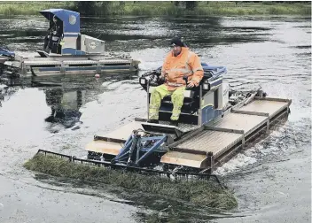  ??  ?? Weed cutting boats in operation at Thorpe Meadows