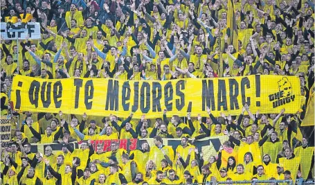  ?? Picture: AP. ?? Dortmund fans hold up a sign saying “Get well, Marc!” for Dortmund’s Spanish defender Marc Bartra who was injured in Tuesday night’s attack on the team bus.