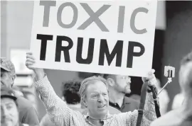  ?? ASSOCIATED PRESS ?? People protest outside the Phoenix Convention Center, in Phoenix. Protests were held against President Donald Trump as he hosted a rally inside the convention center.