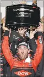  ?? TERRY RENNA — AP ?? Austin Dillon hoists the trophy in Victory lane after Sunday’s win at Daytona.