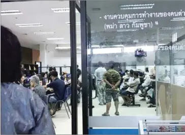  ?? HUMAN RIGHTS AND DEVELOPMEN­T FOUNDATION IN THAILAND/SUPPLIED ?? Migrant workers wait to be processed at the registrati­on centre in Chiang Mai in Thailand earlier this month.