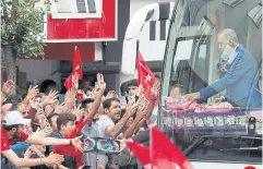  ?? ?? WINNING HEARTS: Turkish President Tayyip Erdogan gives presents to supporters during a rally in Istanbul on Friday.