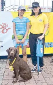  ??  ?? Dock Diving competitio­n runner up Kristine Duque with her Labrador Aber with Pet Express AVP for marketing Janine Ngo