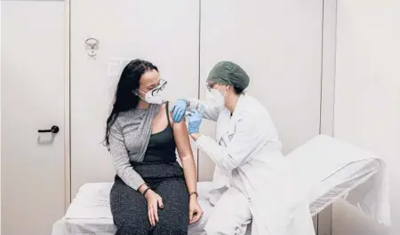  ?? ALESSANDRO GRASSANI/THE NEW YORK TIMES ?? A woman receives a vaccine for COVID-19 Dec. 27 at a hospital in Piacenza, Italy.