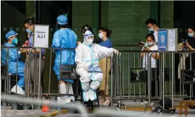  ?? Photograph: Alex Plavevski/EPA ?? People stand in line for a mandatory Covid tests in Shanghai, China.