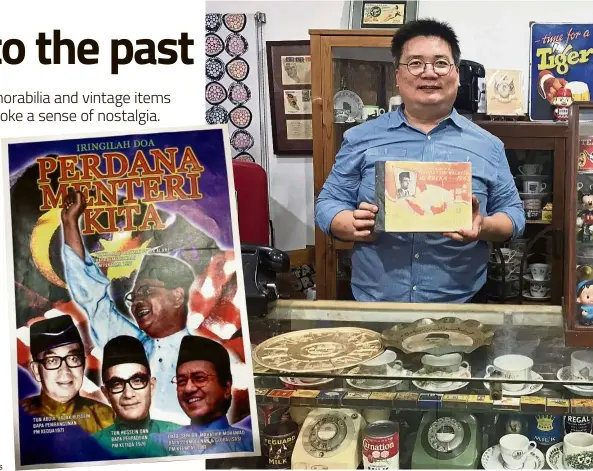  ?? — ADRIAN UNG ?? This poster, showing the past Prime Ministers of Malaysia, is in Ung’s collection. Ung showing a Merdeka Yearbook featuring Tunku Abdul Rahman, the first Prime Minister of Malaysia.