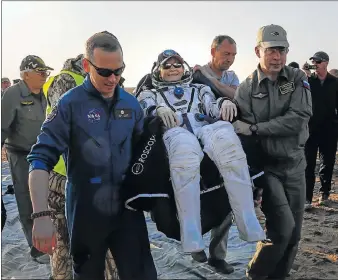  ?? Picture: AFP ?? HOME SAFELY: Ground personnel carry Internatio­nal Space Station (ISS) crew member Nasa astronaut Peggy Annette Whitson after she landed via the Soyuz MS-04 capsule in Kazakhstan yesterday