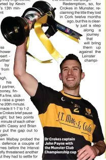  ??  ?? Dr Crokes captain John Payne with the Munster Club Championsh­ip cup