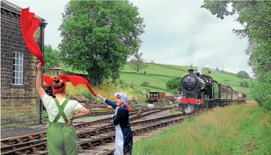  ?? ?? Stopping the last train of the event: Volunteers stage a Railway Children cameo re-enactment, bringing Midland 4F No. 43924 with the vintage carriage rake to a halt as it arrives at Oakworth on August 30.