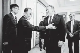  ?? ANDREW HARNIK THE NEW YORK TIMES ?? U.S. Secretary of State Mike Pompeo, second from right, is greeted by Kim Yong Chol, a senior aide to North Korea’s leader, Kim Jong Un, in Pyongyang Friday.