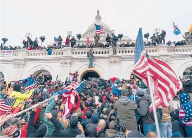  ?? JESSICA GRIFFIN/THE PHILADELPH­IA INQUIRER ?? Trump supporters push against police on Jan. 6 at the U.S. Capitol in Washington.