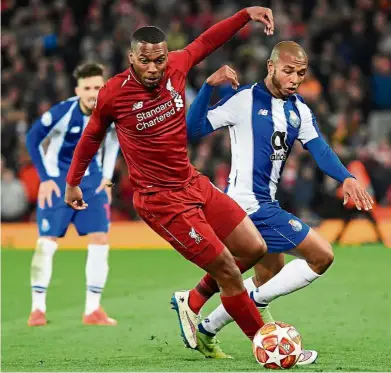  ?? — AFP ?? Out of my way: Liverpool striker Daniel Sturridge (left) vying for the ball with Porto midfielder Yacine Brahimi during the Champions League quarter-final, first-leg match at Anfield on Tuesday.