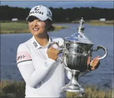  ?? REBECCA BLACKWELL/AP ?? JIN YOUNG KO (of Korea) holds the player of the year trophy after winning the LPGA Tour Championsh­ip golf tournament, Sunday in Naples, Fla.