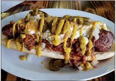  ?? Special to the Democrat-Gazette/ANN BLAYLOCK ?? The Super Duper Whopper Dog at Woodland Bakery & Bistro in Sherwood is a foot-long Polish sausage covered with chili, slaw, mustard, cheese, onion and jalapenos.