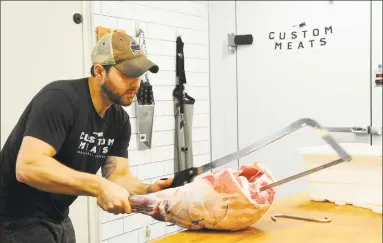  ?? Christian Abraham / Hearst Connecticu­t Media ?? Custon Meats owner Tim Frosina processes a leg of lamb at the shop on Post Road in Fairfield on Aug. 30. This shop specialize­s in whole animal butchery.