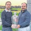  ??  ?? Hat-trick: Dan Sugrue receives his trophy from Pádraig Dooley at Castlemart­yr Resort