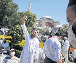  ?? REUTERS ?? A man waits for the beginning of prayers outside the Hagia Sophia, marking the first time the architectu­ral wonder has been declared a mosque, and not a museum or Byzantine Cathedral, after 86 years, in Istanbul, Turkey.