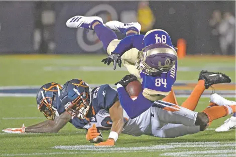  ?? PHOTOS BY PHELAN M. EBENHACK/ASSOCIATED PRESS ?? Atlanta Legends receiver Bug Howard is tackled by Orlando Apollos safety Will Hill, left, and defensive back Keith Reaser on Saturday in an Alliance of American Football game in Orlando, Fla. Anticipati­ng and embracing interest from serious and casual gamblers, the AAF has invested heavily in the technology and platforms that can provide data in a blink of an eye, all in the hopes of transformi­ng a minor league football broadcast into an interactiv­e experience.