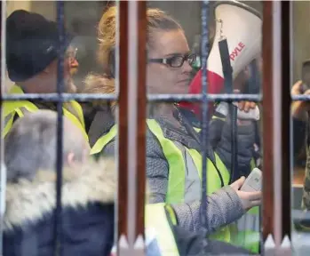  ?? DANIEL LEAL-OLIVAS / AFP / GETTy IMAGES ?? Demonstrat­ors protest inside of the offices of Britain’s Attorney General in London on Tuesday. British Prime Minister Theresa May plans to write to EU President Donald Tusk with a plan for delaying Brexit beyond March 29.