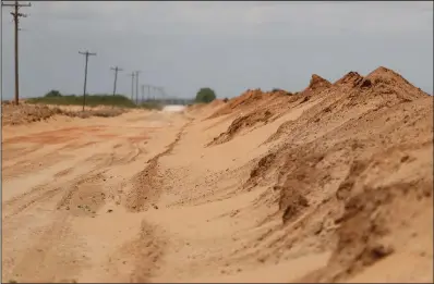  ??  ?? Sand that blew off farmers’ fields is piled up in a ditch May 18 outside Lingo, N.M., near the Texas-new Mexico border. The U.S. Department of Agricultur­e is encouragin­g farmers in a “Dust Bowl zone” that includes parts of Texas, New Mexico, Oklahoma, Kansas and Colorado to establish and preserve grasslands to prevent wind erosion as the area becomes increasing­ly dry.