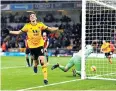  ??  ?? In front: Raul Jimenez celebrates putting Wolves ahead after a Charlie Daniels error