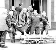  ??  ?? Medics work at the site of an explosion at an office of Russia’s Federal Security Service (FSB) in the city of Arkhangels­k, Russia. — Reuters photo