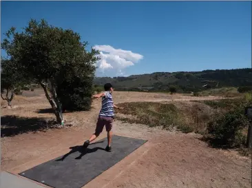  ?? PHOTOS BY TESS KENNY — MONTEREY HERALD ?? Dustin Johnson, Monterey Stinging Jellies Disc Golf Club member and recent graduate of CSU Monterey Bay, puts the newly reopened Ryan Ranch Disc Golf Course in Monterey to use on Wednesday.