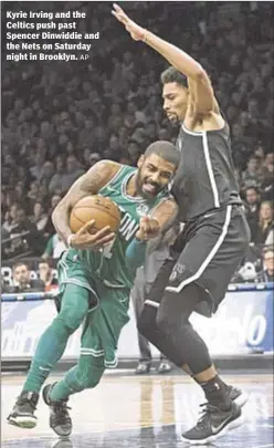  ?? AP ?? Kyrie Irving and the Celtics push past Spencer Dinwiddie and the Nets on Saturday night in Brooklyn.