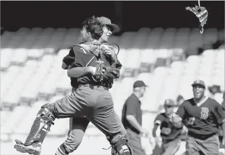  ?? Photograph­s by Luis Sinco Los Angeles Times ?? BIRMINGHAM PITCHER Eddie Rosales, in cap, celebrates a Division I championsh­ip with catcher Johnny Tincher on Saturday.