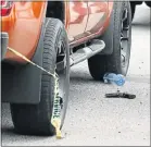  ?? Picture: WERNER HILLS ?? KEY EVIDENCE: A firearm lies next to the double cab the suspects were driving