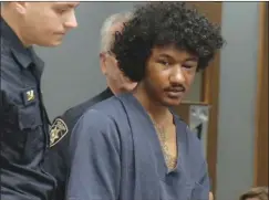  ?? Photo courtesy WJAR/NBC10 ?? Tyler Chandler is led into court on Tuesday morning, the day after he was arrested in Woonsocket for allegedly shooting a police officer.