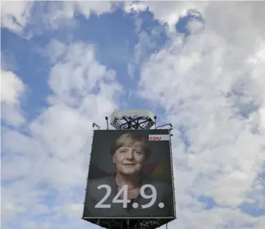  ?? JAN WOITAS/THE ASSOCIATED PRESS ?? A giant poster of German Chancellor Angela Merkel, with the date for the parliament election, in eastern Germany.