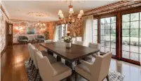  ??  ?? The dining room has chandelier­s, floor-to-ceiling windows, a garden door patio walkout and a garden door sunroom walkout.