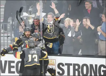  ?? SAM MORRIS / LAS VEGAS NEWS BUREAU (2017) ?? Golden Knights defenseman Deryk Engelland (5) celebrates his goal with teammates Brendan Leipsic (13) and Jonathan Marchessau­lt (81) during the Knights first-ever regular-season home game Oct. 10, 2017, at T-mobile Arena. The Knights won 5-2 in an emotion-filled just days after 58 people were killed in a mass shooting on the Las Vegas Strip. During a pregame ceremony, the Golden Knights paid tribute to those killed, those who survived the shooting and first responders on the scene.