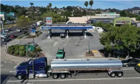  ??  ?? A fuel truck drives by a Chevron station in Richmond, California. Photograph: Justin Sullivan/Getty Images