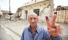  ?? AFP ?? A Mosul resident shows his index finger after voting yesterday in western Zanjili neighbourh­ood, still partially in ruins from the devastatin­g months-long fight against Daesh.