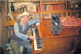  ??  ?? Dave at the Bluthner piano with Pip the cat