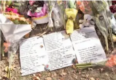  ?? — AFP photo ?? A tribute listing the victims of the mosque attacks is placed at a memorial site in Christchur­ch.