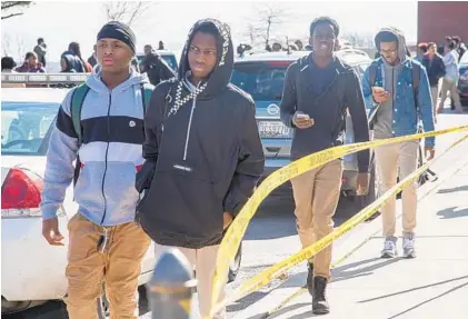 ?? ULYSSES MUNOZ/BALTIMORE SUN ?? Students at Frederick Douglass High School were dismissed early after a 56-year-old staff member was shot inside the building Friday afternoon. Officials say a 25-year-old man entered the school shortly after noon and wounded a special education assistant.