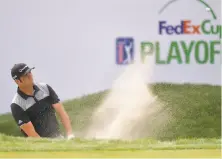  ?? Drew Hallowell / Getty Images ?? Jon Rahm plays out of the bunker on the 17th hole during the second round of the FedEx Cup playoff event at TPC Boston.