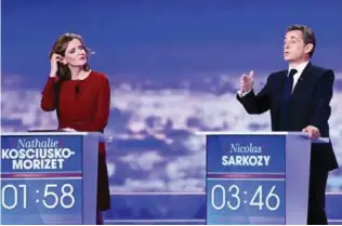  ?? — AFP ?? LA PLAINE-SAINT-DENIS, France : French lawmaker and candidate for the rightwing Les Republicai­ns (LR) party primaries Nathalie Kosciusko-Morizet looks at former French president and candidate during the first televised debate between the seven...