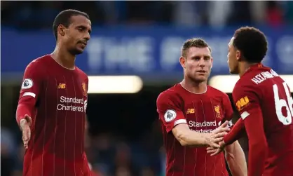  ?? Photograph: James Williamson AMA/Getty Images ?? Joël Matip (left) and James Milner celebrate Liverpool’s victory at Chelsea with Trent Alexander-Arnold.