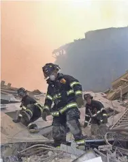  ?? FILE PHOTO/USA TODAY NETWORK ?? New York City firefighte­rs work through the debris at Ground Zero on Sept. 11, 2001, in a desperate search for survivors.