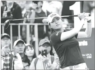  ?? AP/CHIANG YING-YING ?? Jin Young Ko of South Korea watches her tee shot on the first hole Oct. 31 during the first round of the Taiwan Swinging Skirts LPGA at the Miramar Golf Country Club in New Taipei City, Taiwan.