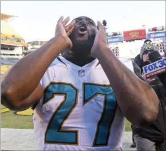  ?? DON WRIGHT — THE ASSOCIATED PRESS ?? Jacksonvil­le Jaguars running back Leonard Fournette (27) celebrates as he walks off the field following a 45-42 win over the Pittsburgh Steelers in an NFL divisional football AFC playoff game in Pittsburgh, Sunday.