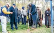  ?? SUBMITTED PHOTO – CHRIS BAKER EVANS ?? State Sen. Andy Dinniman, center left, looks on as Apostle Bobby Duncan, Founder and Pastor of Greater Deliveranc­e Church in Coatesvill­e, right, digs soil from the site of the lynching of Zachariah Walker to be preserved in the Equal Justice Initiative...