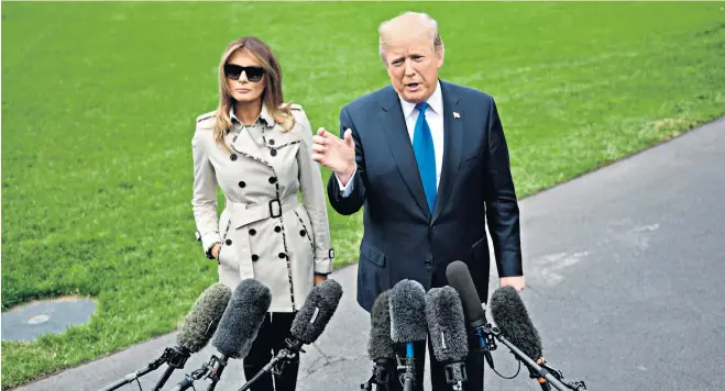  ??  ?? Framed by the White House lawn, Donald Trump, with the First Lady, talks to reporters prior to his departure for an engagement in Maryland. Earlier he had laid out his opposition to a possible easing of sanctions on Iran. He described the 2015 Iranian...